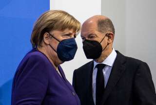German Chancellor Angela Merkel (L) and her designated successor Olaf Scholz arrive for a press conference following a meeting with the heads of government of Germany's federal states at the Chancellery in Berlin on December 2, 2021 on measures to be taken to curb the coronavirus (Covid-19) pandemic. (Photo by John MACDOUGALL / POOL / AFP) (Photo by JOHN MACDOUGALL/POOL/AFP via Getty Images)