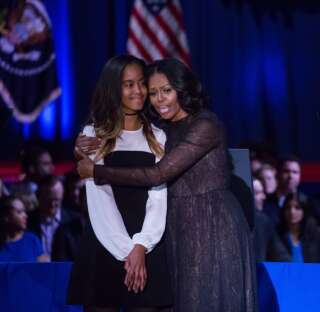On Tuesday, January 10, (l-r), Malia Obama, and her mom, First Lady Michelle Obama, share a hug onstage, after U.S. President Barack Obama delivered his farewell address to the American people at McCormick Place Convention Center.  (Photo by Cheriss May/NurPhoto via Getty Images)