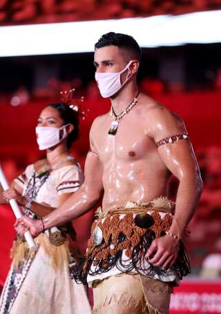 TOKYO, JAPAN - JULY 23: Flag bearer Pita Taufatofua of Team Tonga leads their team out during the Opening Ceremony of the Tokyo 2020 Olympic Games at Olympic Stadium on July 23, 2021 in Tokyo, Japan. (Photo by Jamie Squire/Getty Images)