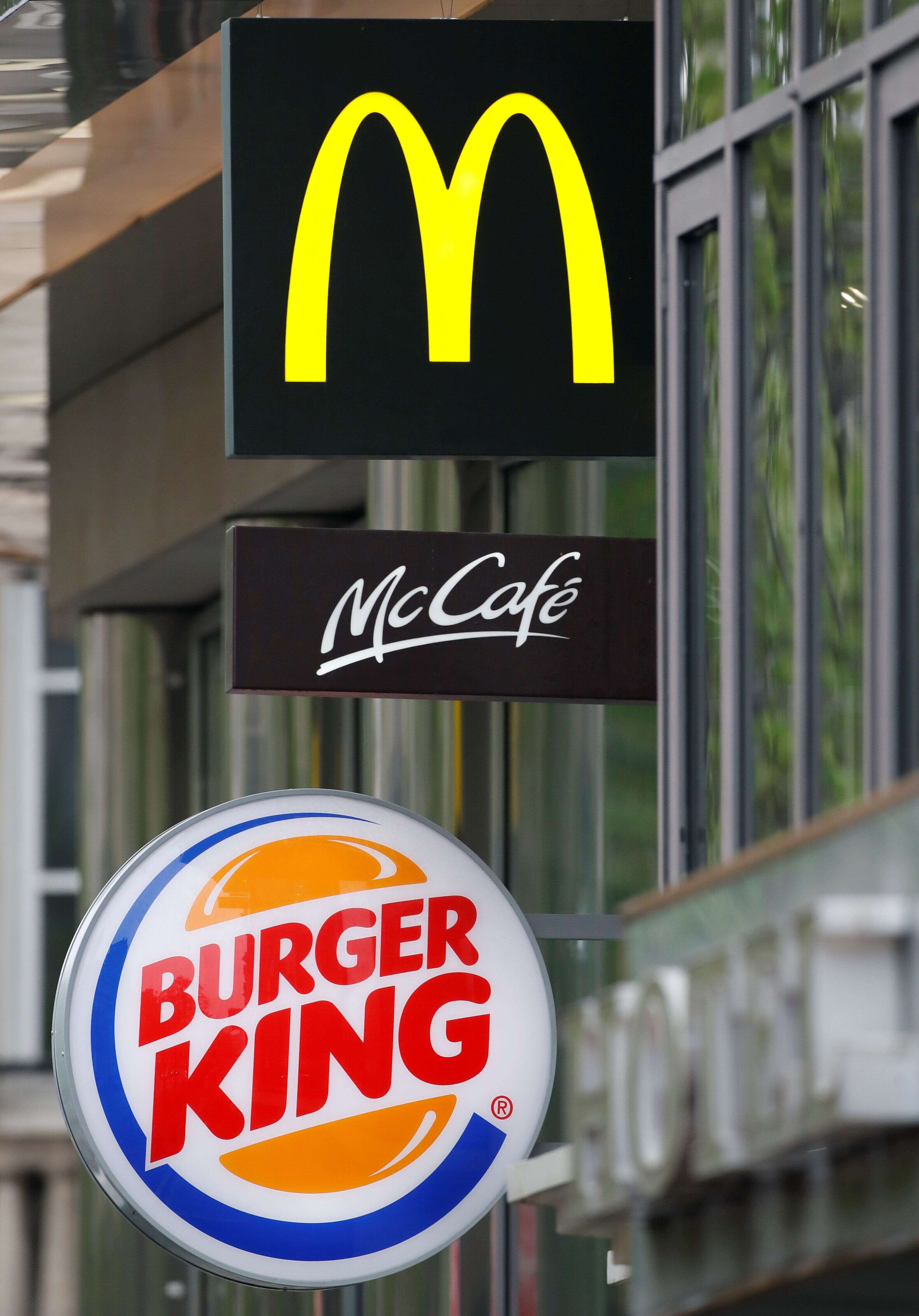 Logos of fast food chains McDonald's and Burger King are seen in front of their restaurants in Paris, France, April 10, 2019. REUTERS/Christian Hartmann