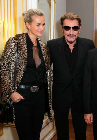 French rock singer Johnny Hallyday and his wife Laeticia attend an award ceremony for U.S actor Harvey Keitel, Tuesday, Oct. 13, 2015 in Paris, France.  (AP Photo/Jacques Brinon)