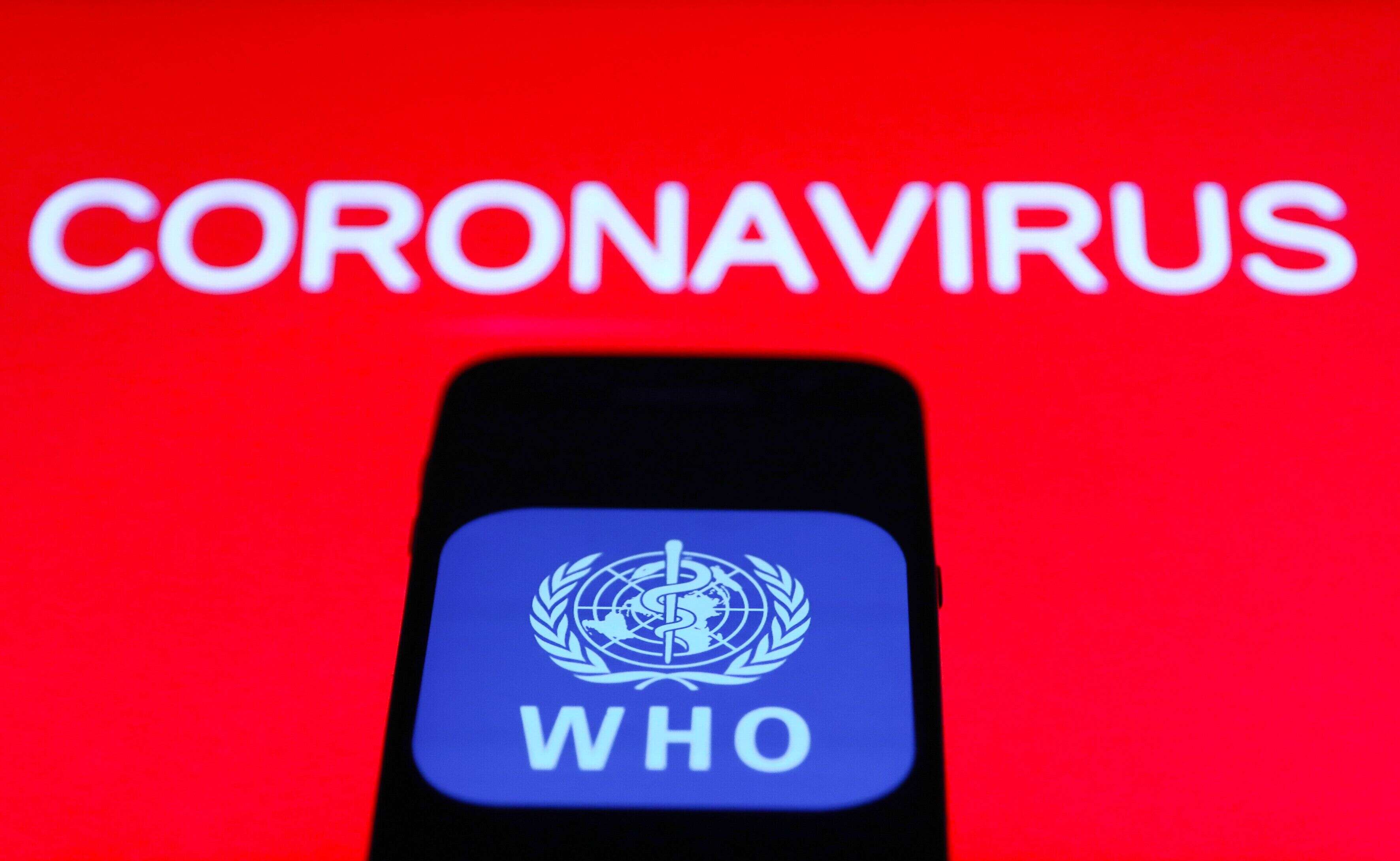 World Health Organization (WHO) app icon is seen on the smartphone screen with coronavirus sign in the background in this illustration photo taken in Poland on March 21, 2020. (Photo by Jakub Porzycki/NurPhoto via Getty Images)