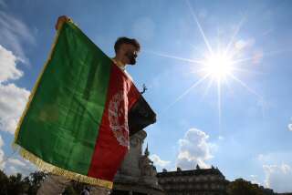 Un homme tient le drapeau national afghan à un rassemblement de soutien au peuple afghan après la prise de contrôle du pays par les talibans, sur la place de la République, à Paris, le 5 septembre 2021.