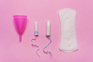 Pad, menstrual cup, tampon on a pink background. The view is flat. Concept of critical days, menstruation