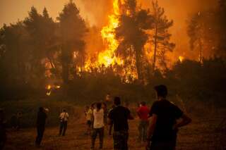 Des habitants de l'île d'Evia (Eubée), la deuxième plus grande île de la Grèce, devant les incendies qui ravagent les forêts, le 8 août 2021