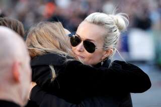 Laura Smet (L) hugs Laeticia Hallyday (R) as they arrive with the funeral cortege behind the coffin of the late French singer Johnny Hallyday prior to the ceremony at the Madeleine church in Paris, France, December 9, 2017.  REUTERS/Yoan Valat/Pool