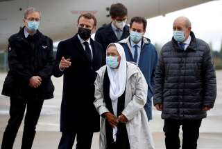 Le président Emmanuel Macron et le ministre des Affaires étrangères Jean-Yves Le Drian accueillant Sophie Petronin à sa libération, ce vendredi 9 octobre 2020. (Gonzalo Fuentes, Pool Photo via AP)