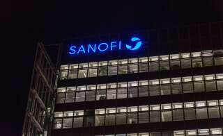 BERLIN, GERMANY - NOVEMBER 13, 2018: City night Potsdamer Platz office building with Sanofi logo. Sanofi is a French multinational pharmaceutical company headquartered in Paris, France.