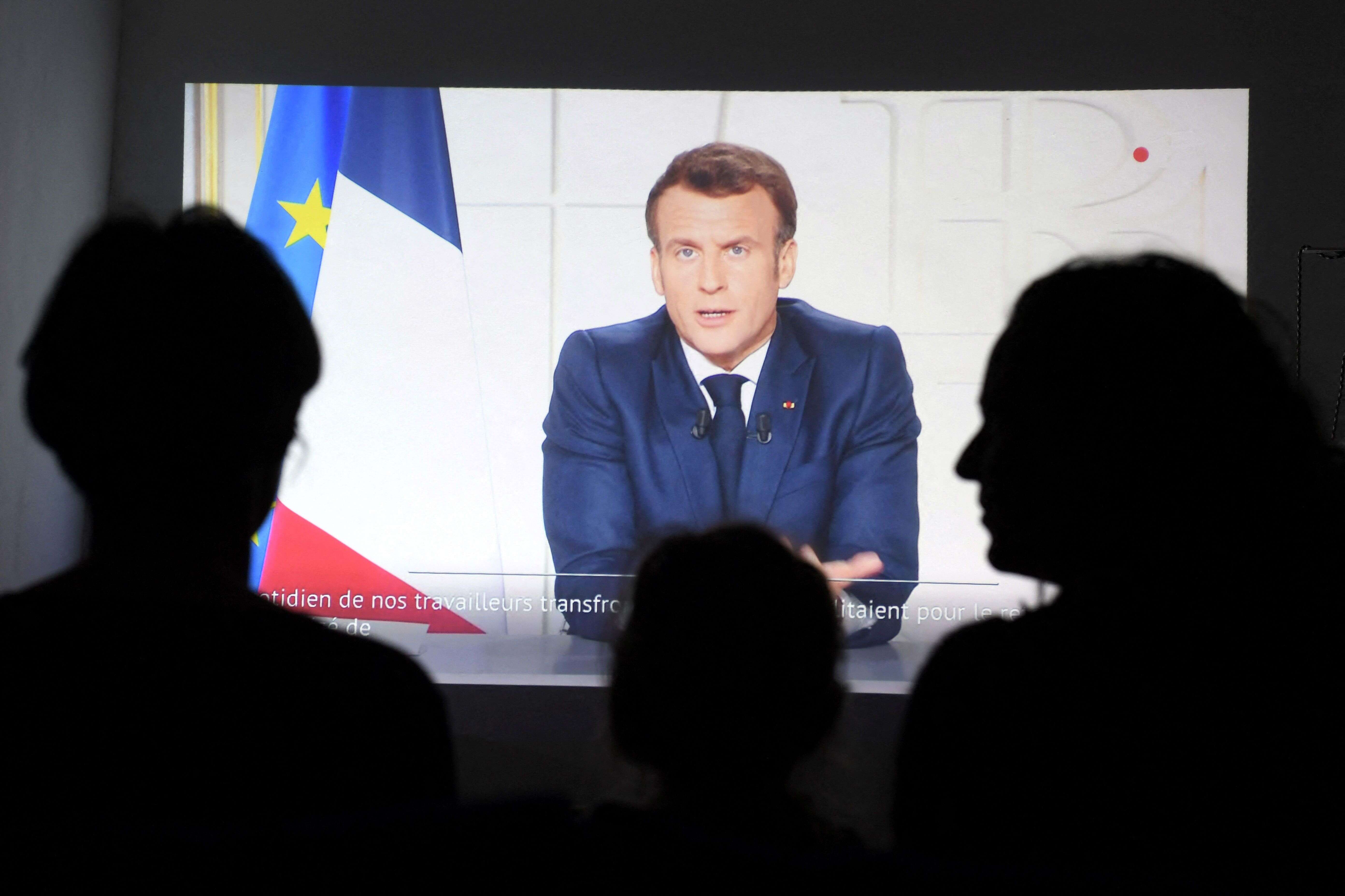Des Français écoutant l'allocution du président Emmanuel Macron le 31 mars 2021 (Photo Nicolas TUCAT / AFP)