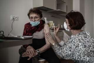 An elderly woman receives an injection of a Covid-19 vaccine at a serviced residence for seniors (a service residence of private housing units for the elderly associated with collective services) at L'Isle-d'Espagnac on February 16, 2021. (Photo by Philippe LOPEZ / AFP) (Photo by PHILIPPE LOPEZ/AFP via Getty Images)