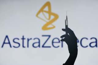 An illustrative image of a hand holding a medical syringe in front of the University of Oxford AstraZeneca logos displayed on a screen. On Monday, February 1, 2021, in Dublin, Ireland. (Photo by Artur Widak/NurPhoto via Getty Images)