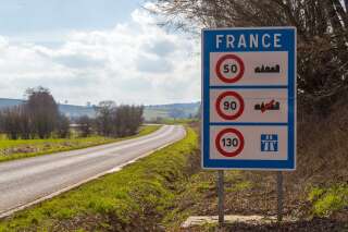 Road sign of return to the French territory with different speed limits along the roads.