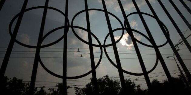 The Olympics rings are seen on a fence in front of the Russian Olympic Committee building in Moscow, Russia, Sunday, July 24, 2016. The IOC has decided against a complete ban on Russian athletes from the Olympics in Rio de Janeiro. The International Olympic Committee says it is leaving it up to global federations to decide which Russian athletes to accept in their sports. (AP Photo/Pavel Golovkin)
