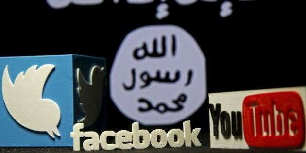 A 3D plastic representation of the Twitter and Youtube logo is seen in front of a displayed ISIS flag in this photo illustration in Zenica, Bosnia and Herzegovina, February 3, 2016. Iraq is trying to persuade satellite firms to halt Internet services in areas under Islamic State's rule, seeking to deal a major blow to the group's potent propaganda machine which relies heavily on social media to inspire its followers to wage jihad. Picture taken February 3, 2016. To match Insight MIDEAST-CRISIS/IRAQ-INTERNET REUTERS/Dado Ruvic      TPX IMAGES OF THE DAY