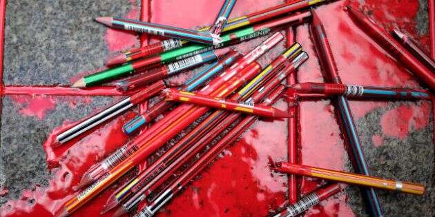 Broken pens lay on the ground as members of a leftist party gather outside the French consulate to pay tribute to the victims of the French satirical newspaper Charlie Hebdo, in Istanbul, Turkey, Friday, Jan. 9, 2015. 12 people were killed on Jan. 7 in a terrorist attack at the Charlie Hebdo headquarters in Paris. (AP Photo/Emrah Gurel)