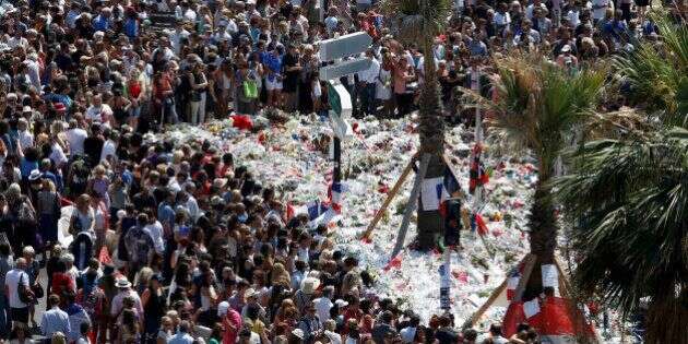 A view shows the crowd gathering near a makeshift memorial on the Promenade des Anglais during a minute of silence on the third day of national mourning to pay tribute to victims of the truck attack along the Promenade des Anglais on Bastille Day that killed scores and injured as many in Nice, France, July 18, 2016.   REUTERS/Eric Gaillard     TPX IMAGES OF THE DAY