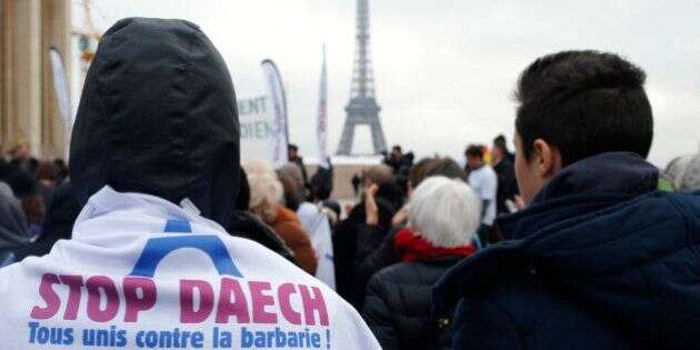 People attend a demontration against Daech with the message on a shirt with the EIffel Tower,