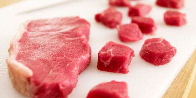 Cubed raw steak on cutting board