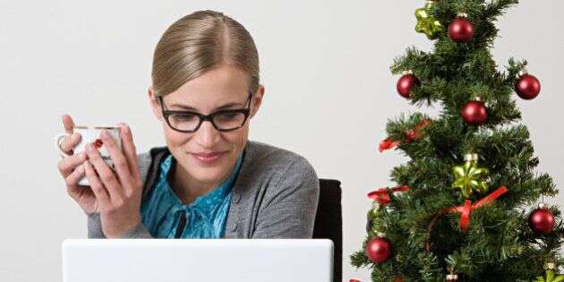 Woman with christmas tree on her desk