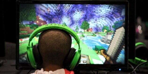 A child plays video game Minecraft at the Minecon convention in London July 4, 2015. The 10,000 tickets sold for Minecon in London made it the largest ever convention for a single video game. REUTERS/Matthew Tostevin