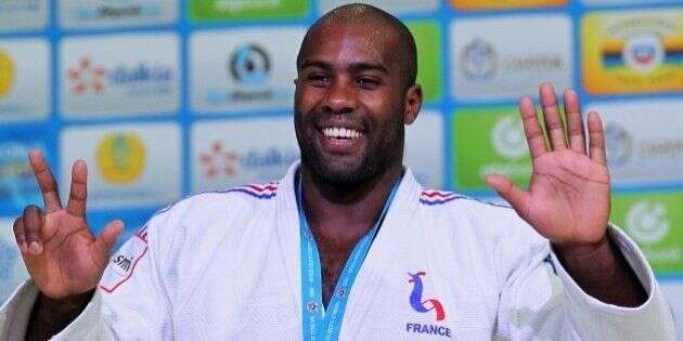 FILE - In this Aug. 29, 2015, file photo, France's Teddy Riner poses during an award ceremony of the men's +100 kg final at the World Judo Championships in Astana, Kazakhstan. The 27-year-old heavyweight has won a record eight world championship titles, five European titles and two Olympic medals, including a gold at the London games. (AP Photo/Alexey Filippov, File)