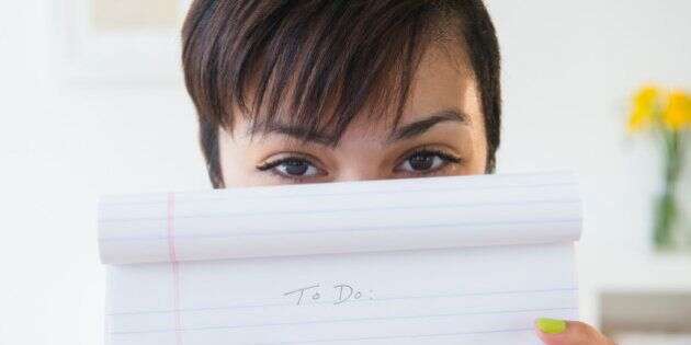 Mixed race woman holding empty to do list