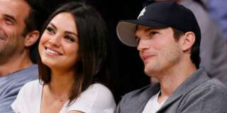 Actress Mila Kunis, left, and actor Ashton Kutcher, right, sit courtside together at the NBA basketball game between the Phoenix Suns and Los Angeles Lakers on Tuesday, February 12, 2013, in Los Angeles. (AP Photo/Danny Moloshok)