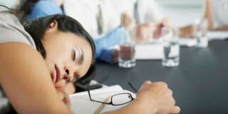 Businesswoman sleeping in conference room during meeting