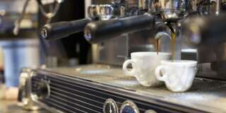 espresso machine pouring coffee into cups