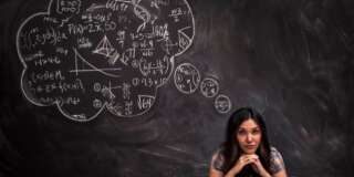 Girl contemplates math thought bubble on chalkboard