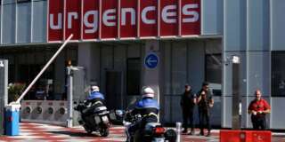 Riot olice officers and gendarmes are pictured outside the Pasteur Hospital in Nice, southern France, Friday July 15, 2016.  A large truck plowed through revelers gathered for Bastille Day fireworks in Nice, killing more than 80 people and sending others fleeing into the sea as it bore down for more than a mile along the Riviera city's famed waterfront promenade. (AP Photo/Claude Paris)