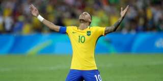 Brazil's Neymar cries as he kneels down to celebrate after scoring the decisive penalty kick during the final match of the men's Olympic football tournament between Brazil and Germany at the Maracana stadium in Rio de Janeiro, Brazil, Saturday Aug. 20, 2016. Brazil won the gold medal on  a penalty shootout. (AP Photo/Andre Penner)