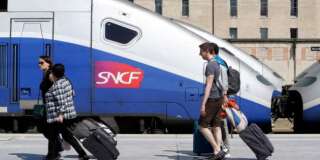 Passengers walk along a platform to take a train at the Gare St-Charles station in Marseille, southern France, Monday June 16, 2014. Workers of the French national railway SNCF are striking over plans to streamline and open the state-run network, considered among the world's best, to private competition. (AP Photo/Claude Paris)