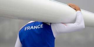 A French rower carries his scull on the dock prior to practice during the 2016 Summer Olympics in Rio de Janeiro, Brazil, Wednesday, Aug. 10, 2016. Rowing competition was postponed due to weather. (AP Photo/Luca Bruno)