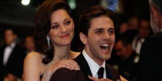 Director Xavier Dolan and cast member Marion Cotillard pose on the red carpet as they arrive for the screening of the film