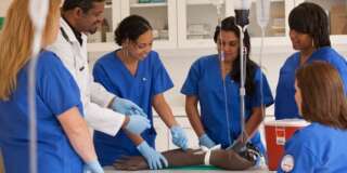 Nurses learning to insert an iv drip in hospital