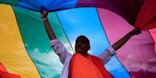A man displays a rainbow flag during a LGBT Pride parade in metro Manila, Philippines June 25, 2016. REUTERS/Romeo Ranoco     TPX IMAGES OF THE DAY