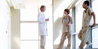 Doctor and nurses discussing in hospital corridor