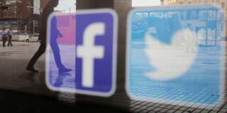 Facebook and Twitter logos are seen on a shop window in Malaga, Spain, June 4, 2018. REUTERS/Jon Nazca