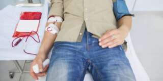 Male patient receiving a blood transfusion in hospital ward