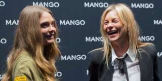 Models Cara Delevingne, left, and Kate Moss pose for photographers as they arrive for the opening of the Mango fashion designer store, during Milan's fashion week, in Milan, Wednesday, Sept. 23, 2015. (AP Photo/Giuseppe Aresu)