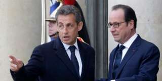 French President Francois Hollande, right, and former French President Nicolas Sarkozy speak on the steps of the Elysee Palace, Paris, Sunday, Jan. 11, 2015. A rally of defiance and sorrow, protected by an unparalleled level of security, on Sunday will honor the 17 victims of three days of bloodshed in Paris that left France on alert for more violence. (AP Photo/Thibault Camus)