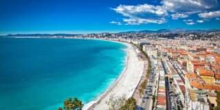 Panoramic view of Nice coastline and beach with blue sky, France.