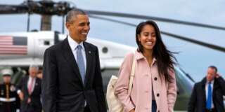 FILE - In a Thursday, April 7, 2016 file photo, President Barack Obama jokes with his daughter Malia Obama as they walk to board Air Force One from the Marine One helicopter, as they leave Chicago en route to Los Angeles.  The White House announced Sunday, May 1, 2016, that Malia Obama will take a year off after high school and attend Harvard University in 2017. (AP Photo/Jacquelyn Martin, File)
