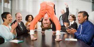 Businesswoman doing backbend at meeting