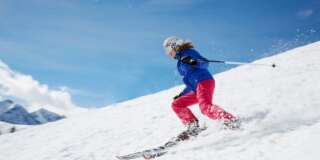 Young woman skiing down mountain