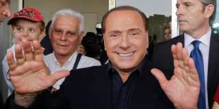AC Milan president Silvio Berlusconi waves to supporters outside the Milanese soccer club's headquarters, in Milan, Italy, Friday, July 3, 2015. Berlusconi has demanded new coach Sinisa Mihajlovic lead the club back into the Champions League. (AP Photo/Luca Bruno)