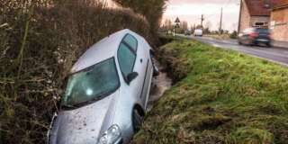 A car lies in a ditch following an accident in the northern French village of Meteren, on January 29, 2015. AFP PHOTO / PHILIPPE HUGUEN        (Photo credit should read PHILIPPE HUGUEN/AFP/Getty Images)