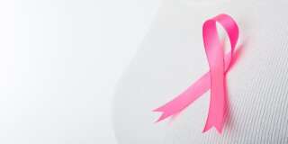 Pink Breast cancer awareness ribbon  by woman who need to show healthcare concept.