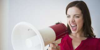 Woman yelling through megaphone